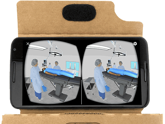 A smartphone displays a virtual reality simulation of a hospital operating room with medical staff and a patient on the table.