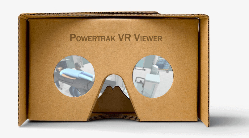 A cardboard VR design viewer labeled Powertrak VR Viewer displaying blurred images through its lenses.